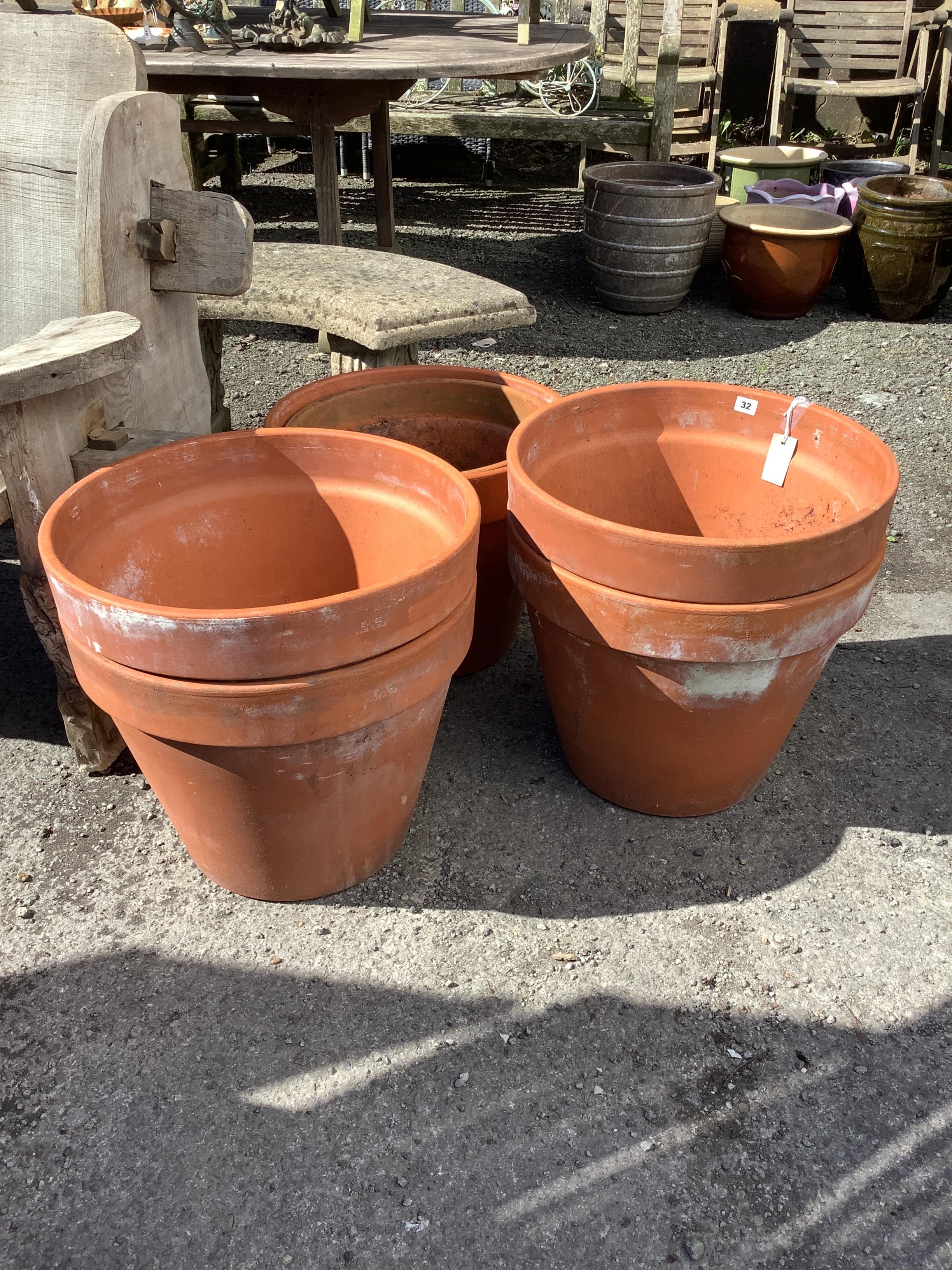 Six large circular terracotta planters, largest diameter 49cm, height 40cm